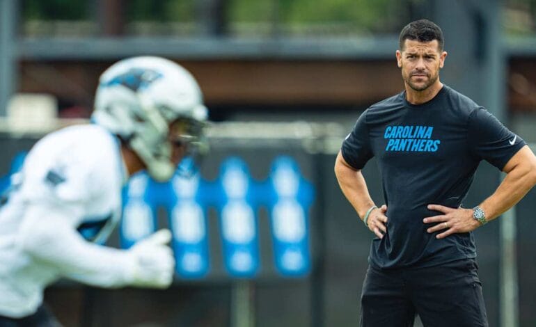 Create a 10-word scroll-stopping headline for: Panthers announce 2026 coaching staff | Vibe NC