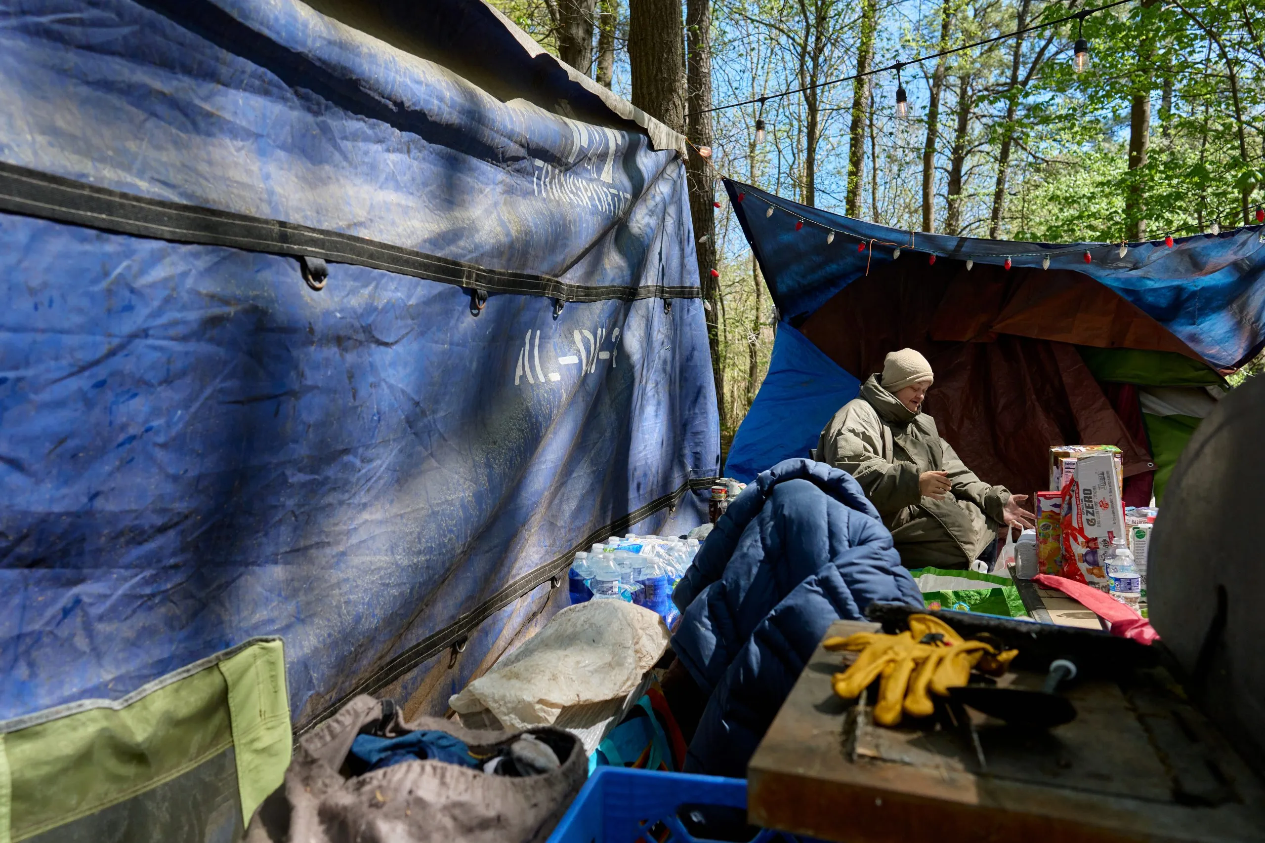 Create a 10-word scroll-stopping headline for: Inside Outlanders, Raleigh’s Self-Governed Homeless Community | Vibe NC
