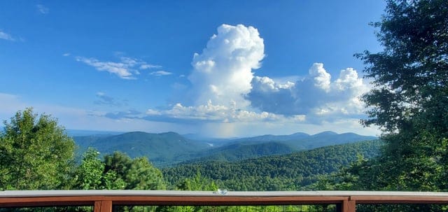 Create a 10-word scroll-stopping headline for: I was not expecting this view from back deck of the place we rented | Vibe NC