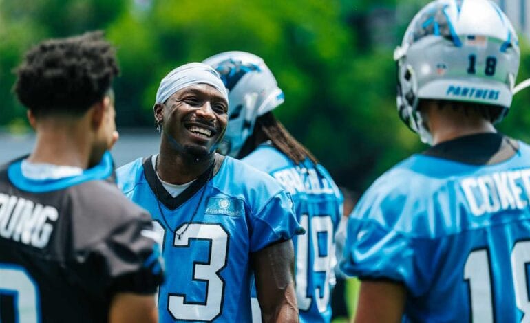 Here are a few options, playing with different angles within 10 words:

Panthers’ Secret Weapon: Moore’s Wit Shapes Receiver Unit’s Rise.
Beyond Catches: Moore’s Wisdom Forges Panthers’ Receiver Unit.
Moore’s Masterclass: Wit and Wisdom Transforming Panthers’ Receivers.
The Brains Behind Panthers’ Receivers: David Moore’s Unseen Impact.
Panthers’ Mind Game: David Moore Elevates Receiver Unit With Wit.
 | Vibe NC